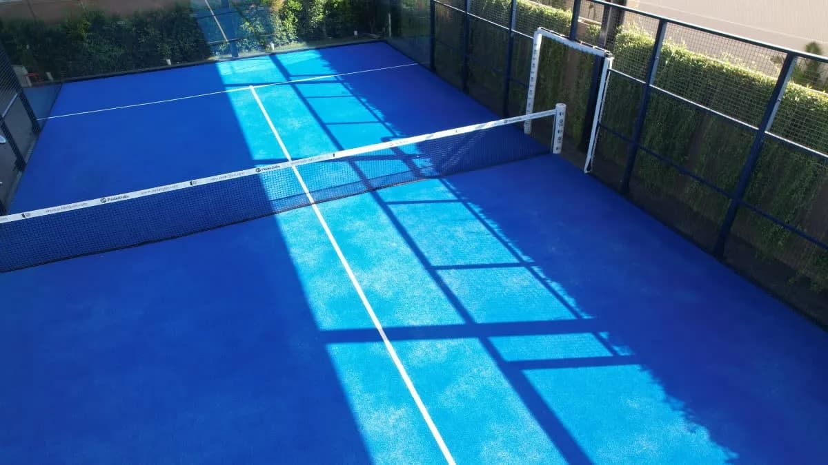 Blue padel court from above at Play By Uluwatu Estate