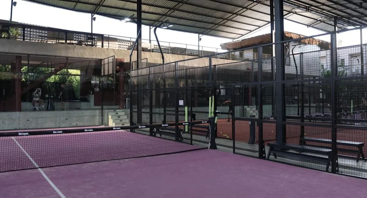Roofed pink padel courts at The Ground Bingin