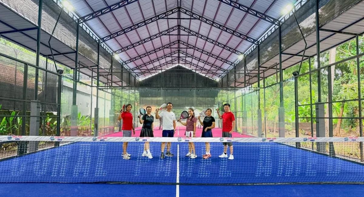 Players on roofed padel courts at Coral Padel Amed