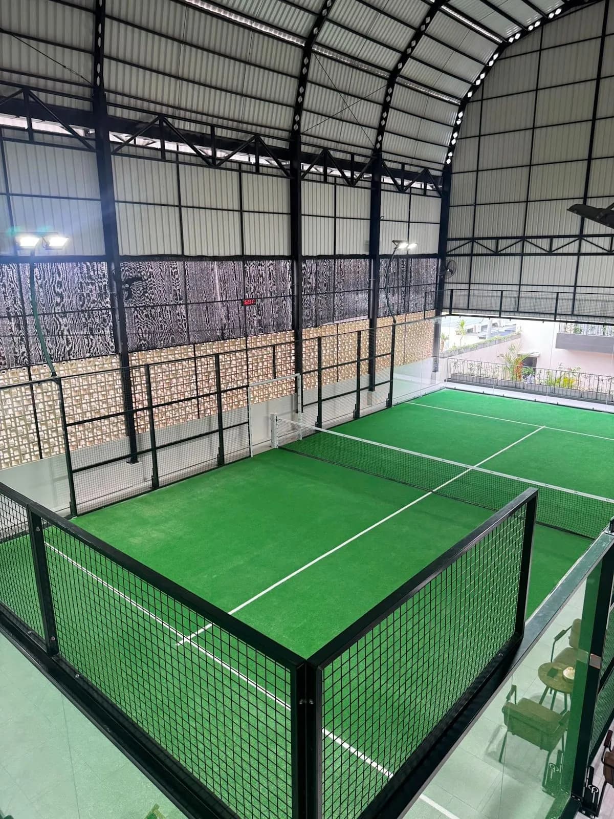 Green indoor padel court at Kaya Padel Canggu Bali